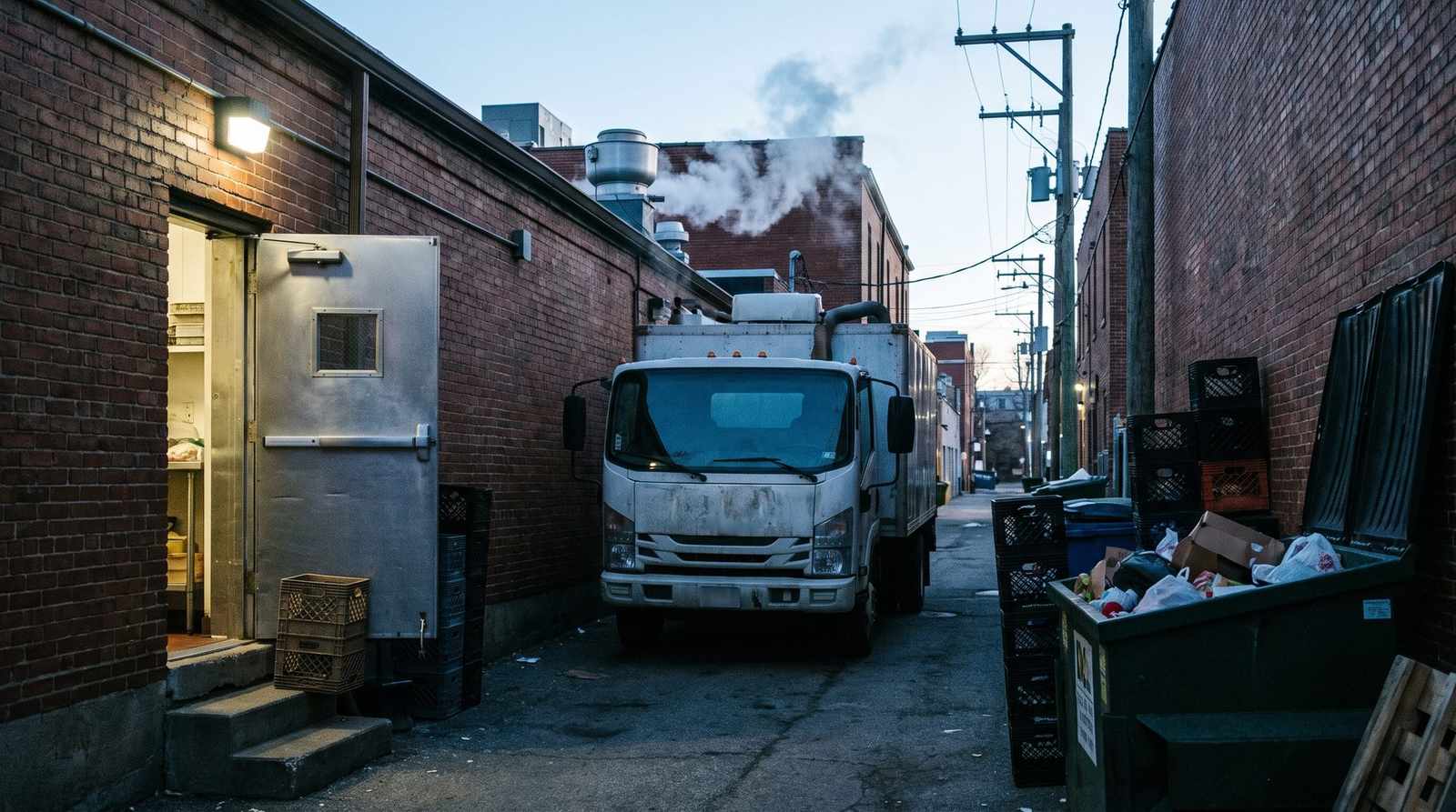 Vacuum truck parked at the back of a Denver restaurant early in the morning