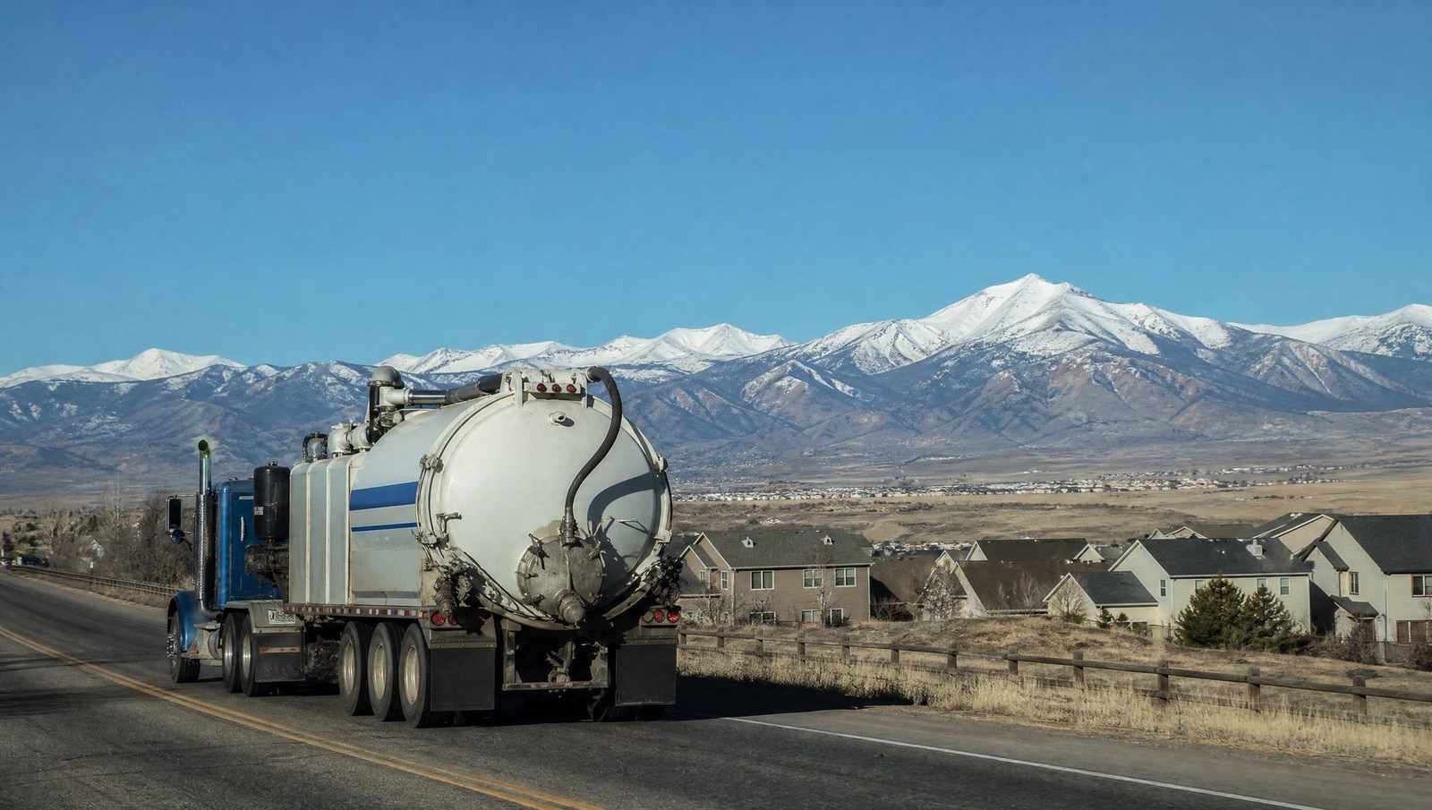 Affordable Septic Pumping vacuum truck on a Front Range road between service calls in Colorado